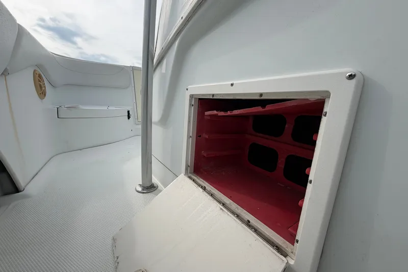 Slide: The Image of 2001 Baja 340 Islander Outboard boat interior with open storage compartment and seating area. - 33