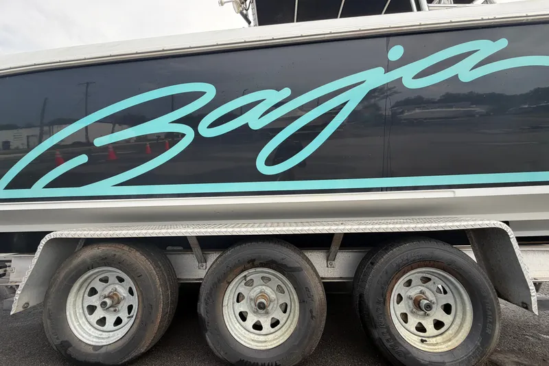 Slide: The Image of 2001 Baja 340 Islander Outboard boat on trailer, showcasing sleek design and branding. - 78