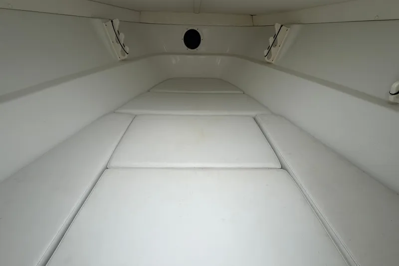 Slide: The Image of Interior cabin of 2001 Baja 340 Islander Outboard boat, featuring white cushioned seating. - 43