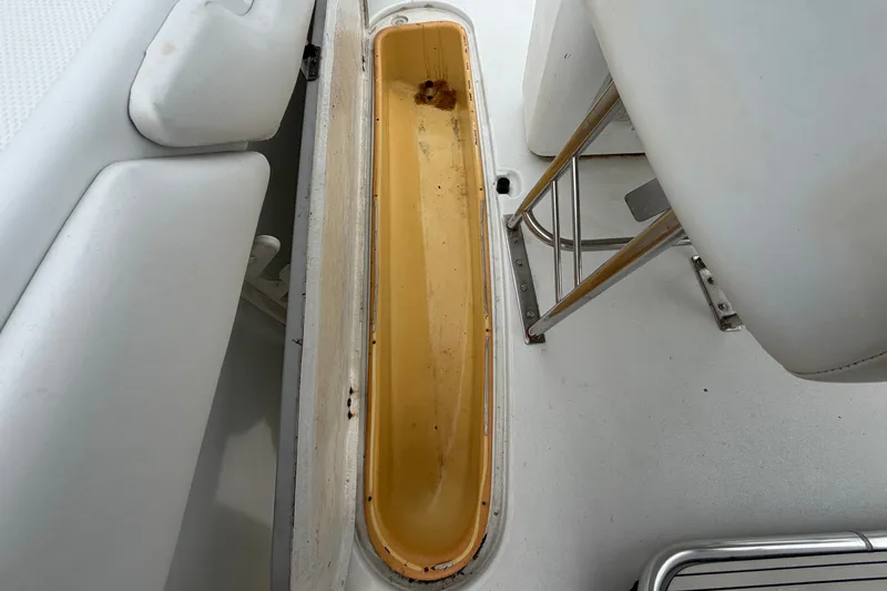 Slide: The Image of 2001 Baja 340 Islander Outboard interior detail, featuring storage compartment and seating area. - 56