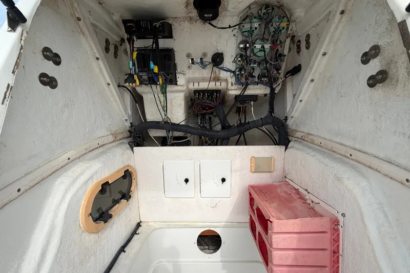 Slide: The Image of Interior view of a 2001 Baja 340 Islander Outboard boat's wiring and storage area. - 50