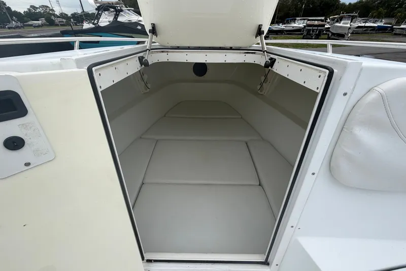Slide: The Image of 2001 Baja 340 Islander Outboard cabin interior with white cushioned seating. - 41