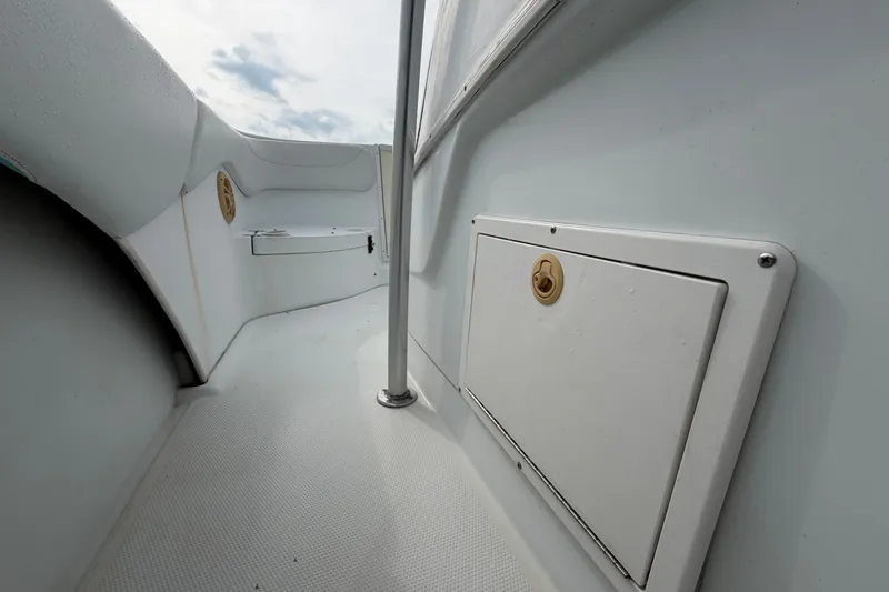 Slide: The Image of 2001 Baja 340 Islander Outboard boat interior with storage compartment and railing. - 32