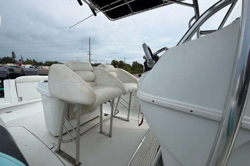 Slide: The Image of 2001 Baja 340 Islander Outboard boat interior with white seating and steering console. - 53