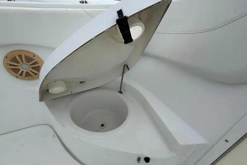 Slide: The Image of 2001 Baja 340 Islander Outboard boat interior with open storage compartment and speaker. - 37