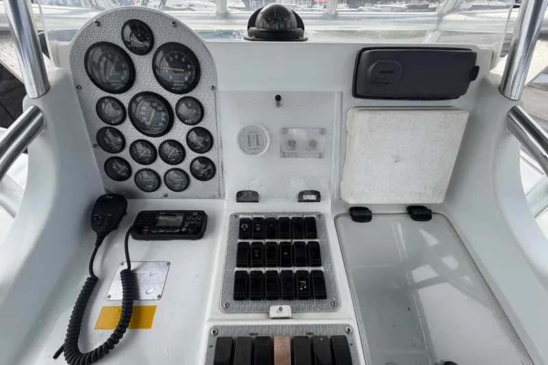 Slide: The Image of Control panel of a 2001 Baja 340 Islander Outboard boat with gauges and radio equipment. - 25