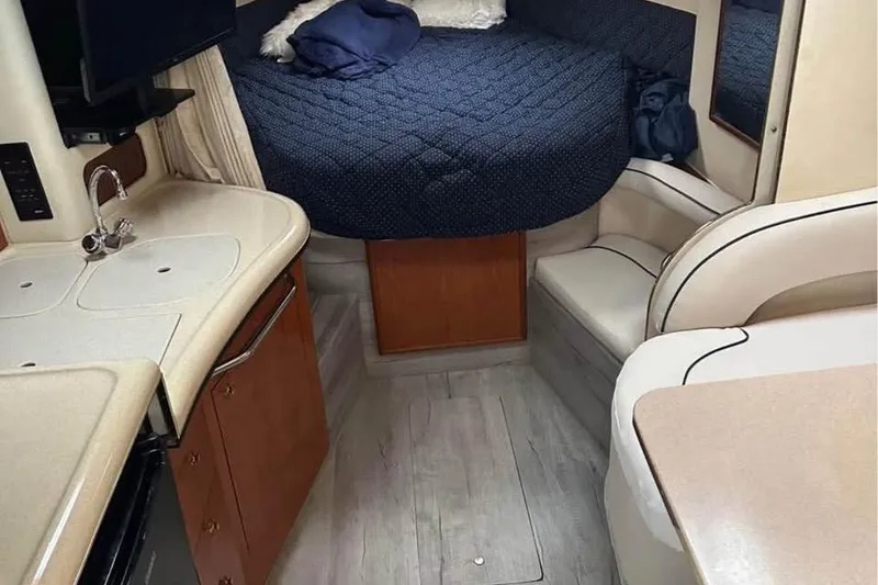 Slide: The Image of Interior of 2001 Sea Ray 340 Sundancer with cozy bed and compact kitchen area. - 7