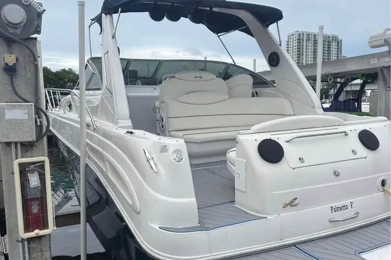 The Image of 2001 Sea Ray 340 Sundancer yacht docked, featuring sleek design and spacious seating area. - 0