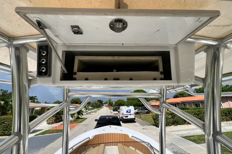 Slide: The Image of 2016 Sportsman Heritage 231 Center Console boat with open storage compartment and street view. - 26