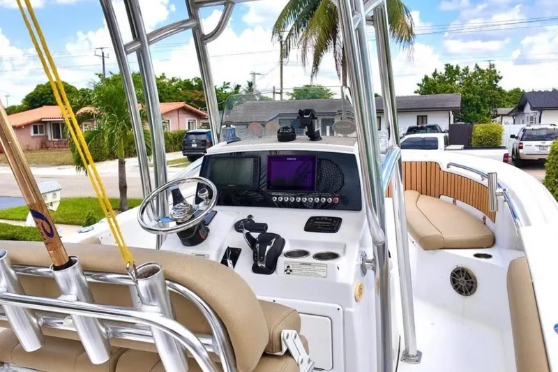 Slide: The Image of 2016 Sportsman Heritage 231 Center Console boat with modern dashboard and seating. - 17