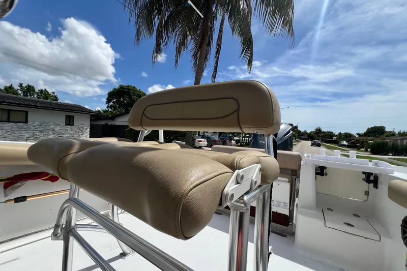 Slide: The Image of 2016 Sportsman Heritage 231 Center Console boat with tan seating under a clear blue sky. - 46