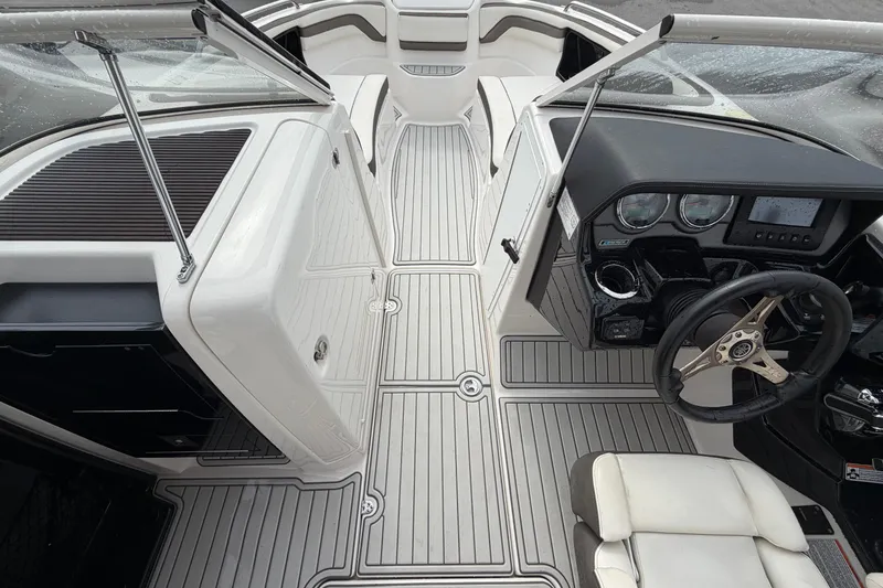 Slide: The Image of 2016 Yamaha Boats 242 Limited S E-Series interior with sleek dashboard and steering wheel. - 24