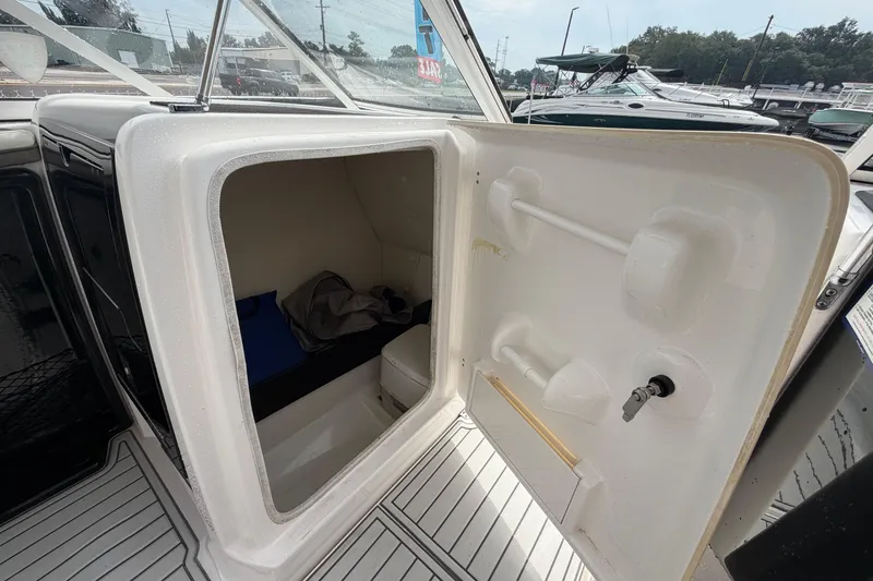 Slide: The Image of 2016 Yamaha Boats 242 Limited S E-Series interior storage compartment open. - 42