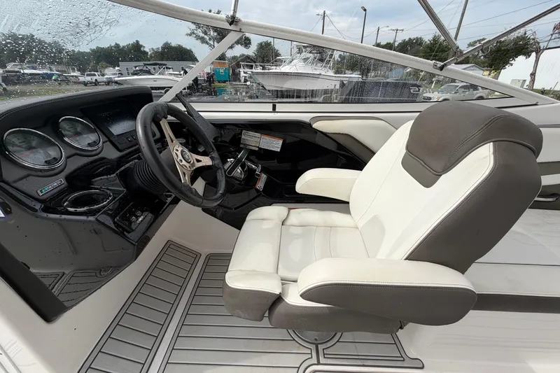 Slide: The Image of 2016 Yamaha Boats 242 Limited S E-Series cockpit with steering wheel and captain's chair. - 18