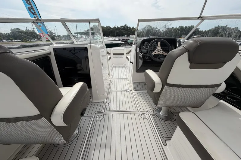 Slide: The Image of 2016 Yamaha Boats 242 Limited S E-Series interior with dual captain's chairs and sleek dashboard. - 17