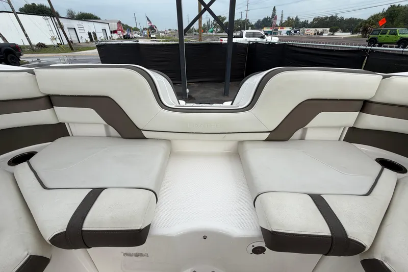 Slide: The Image of 2016 Yamaha Boats 242 Limited S E-Series interior seating, featuring white and brown upholstery. - 51