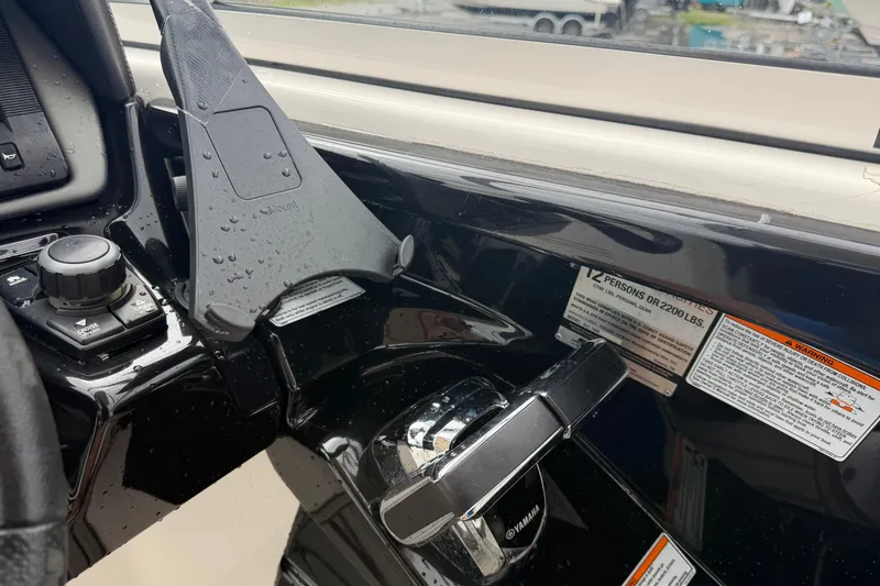 Slide: The Image of Control panel of a 2016 Yamaha Boats 242 Limited S E-Series, featuring throttle and capacity labels. - 23
