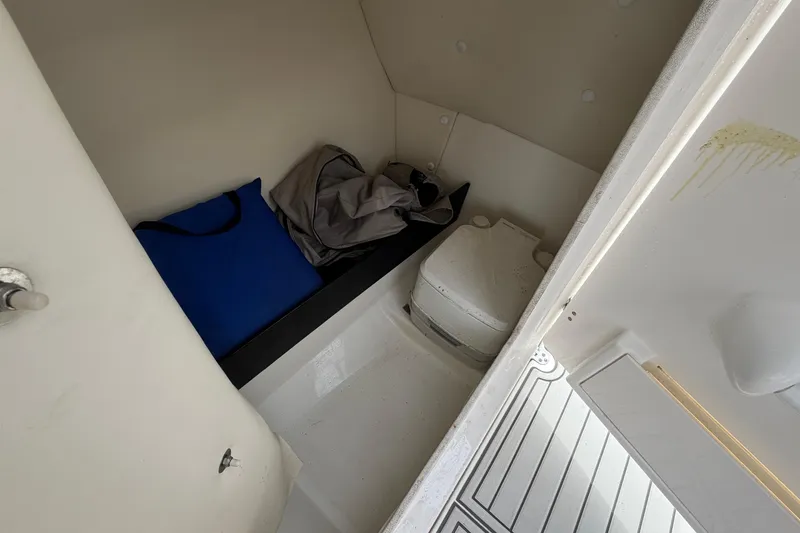 Slide: The Image of Interior cabin of 2016 Yamaha Boats 242 Limited S E-Series with storage and portable toilet. - 43