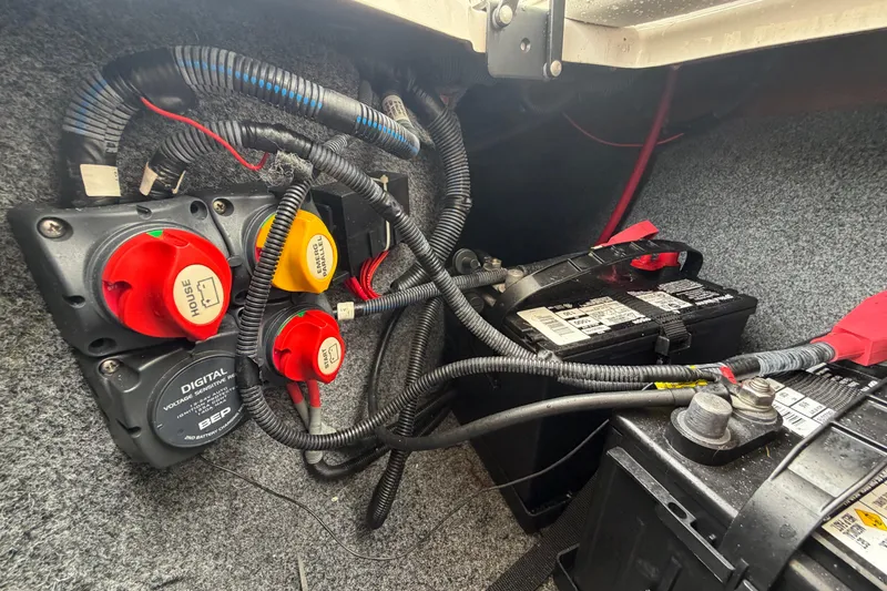 Slide: The Image of Battery compartment of a 2016 Yamaha Boats 242 Limited S E-Series, showing wiring and switches. - 58