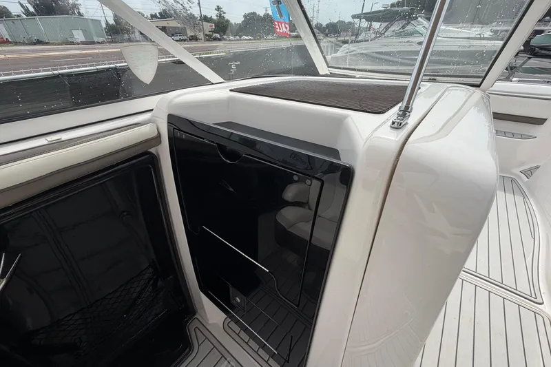 Slide: The Image of 2016 Yamaha Boats 242 Limited S E-Series interior with sleek black and white design. - 44