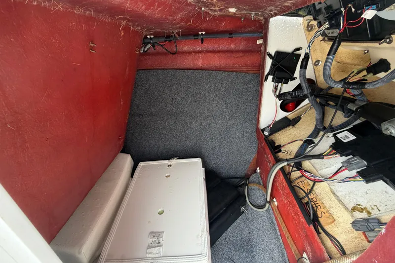 Slide: The Image of Interior view of a 2016 Yamaha Boats 242 Limited S E-Series, showcasing wiring and storage area. - 29