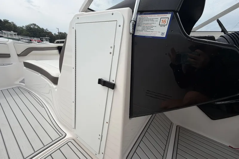 Slide: The Image of 2016 Yamaha Boats 242 Limited S E-Series interior with seating and storage compartment. - 28