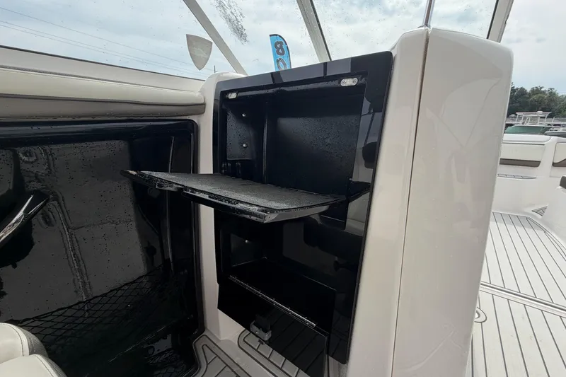 Slide: The Image of 2016 Yamaha Boats 242 Limited S E-Series interior storage compartment with open door. - 45