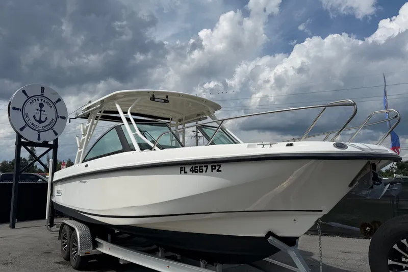 The Image of 2015 Boston Whaler 270 Vantage boat on trailer under cloudy sky. - 0