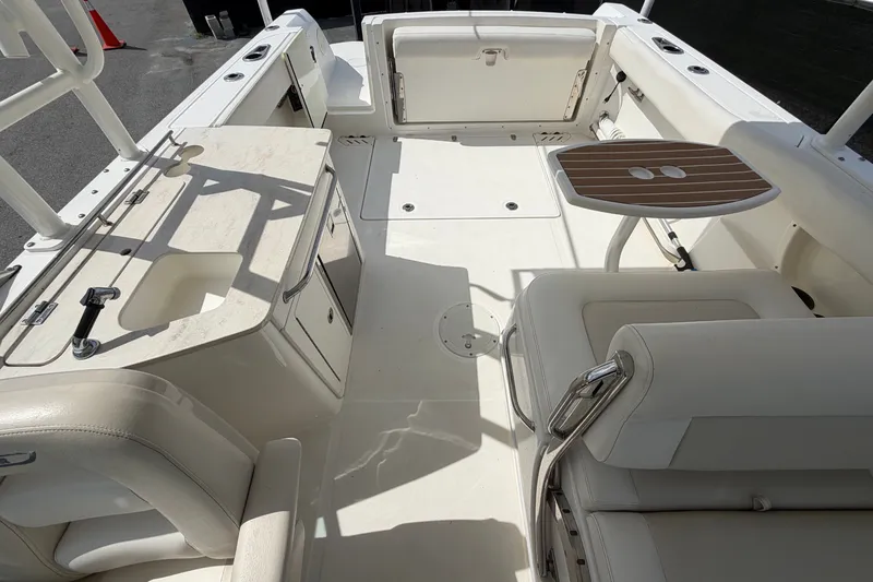 Slide: The Image of 2015 Boston Whaler 270 Vantage boat interior with seating and storage compartments. - 64
