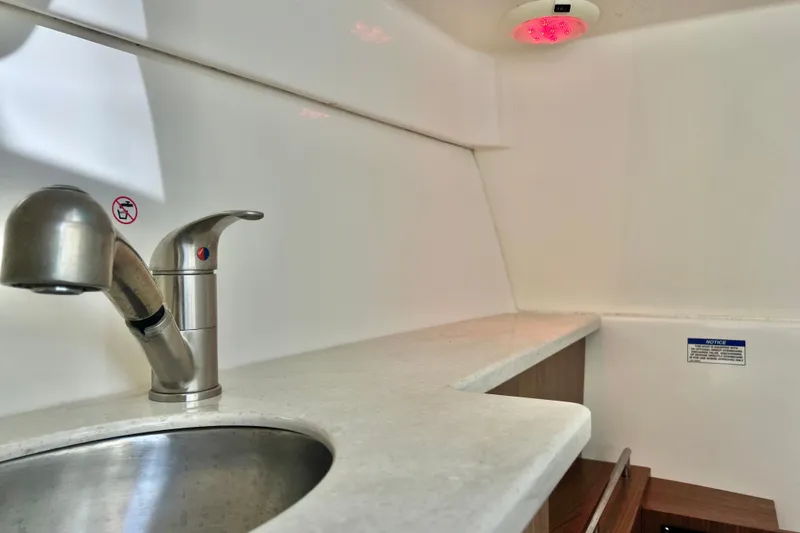 Slide: The Image of Interior of 2015 Boston Whaler 270 Vantage boat with sink and countertop. - 87