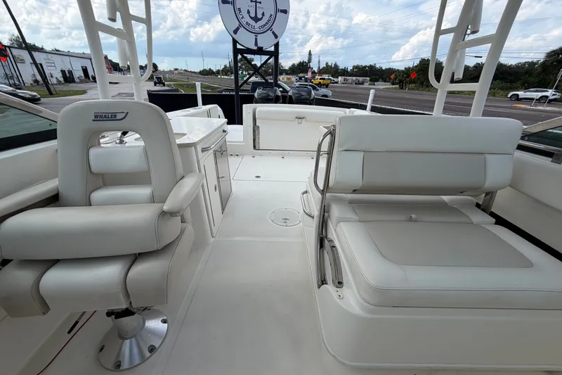 Slide: The Image of 2015 Boston Whaler 270 Vantage boat interior with white seating and helm. - 61