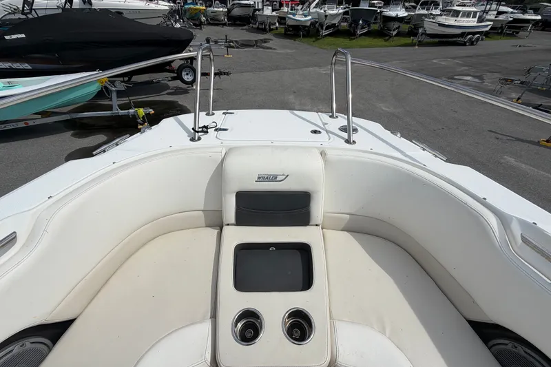 Slide: The Image of 2015 Boston Whaler 270 Vantage boat interior with seating and cup holders. - 50