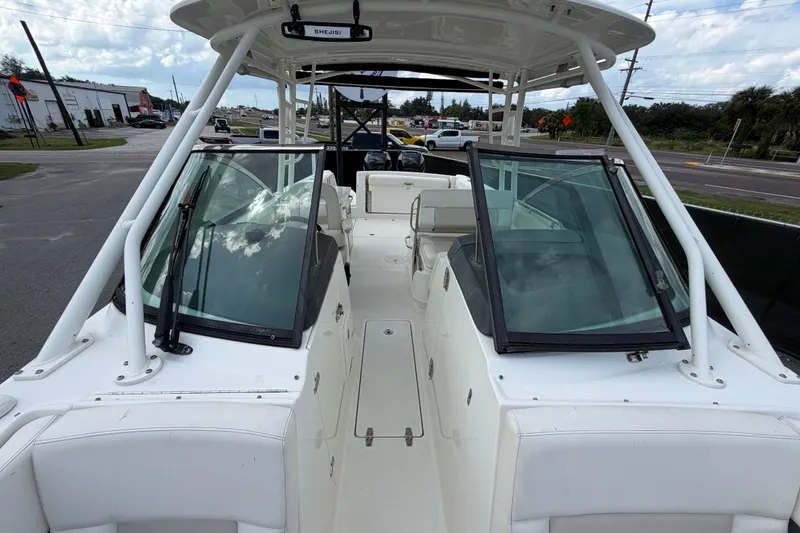 Slide: The Image of 2015 Boston Whaler 270 Vantage boat interior with open windshield and seating. - 59