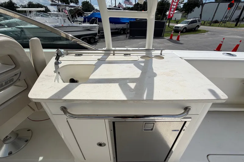 Slide: The Image of 2015 Boston Whaler 270 Vantage boat interior with sink and storage area. - 20