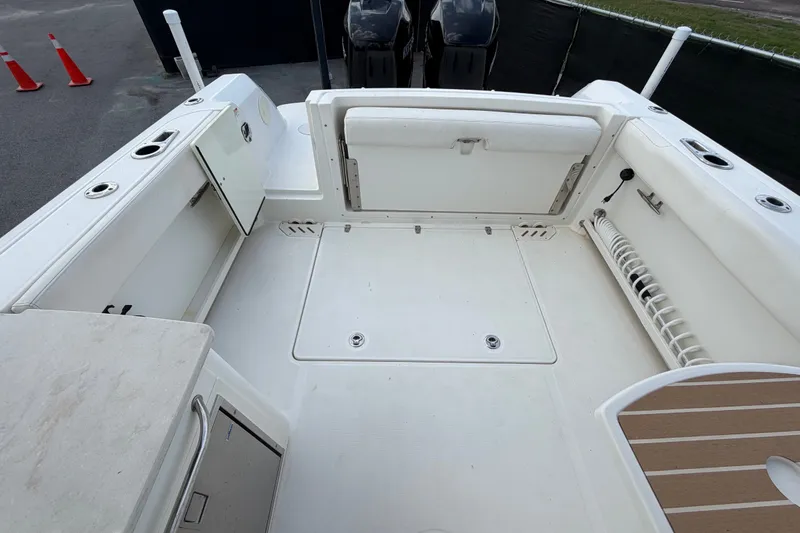 Slide: The Image of 2015 Boston Whaler 270 Vantage boat deck, featuring spacious seating and storage compartments. - 68