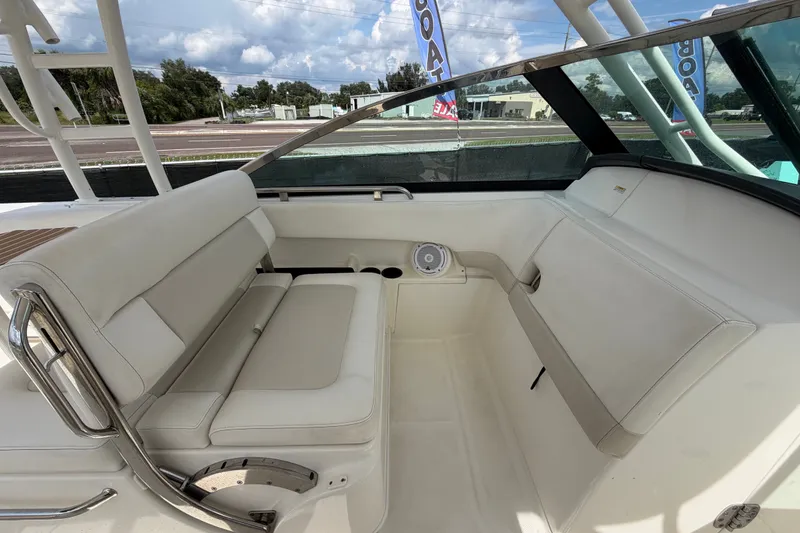 Slide: The Image of 2015 Boston Whaler 270 Vantage interior with white seating and stainless steel accents. - 27
