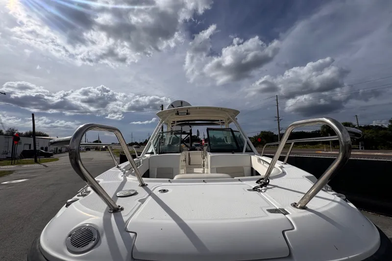 Slide: The Image of 2015 Boston Whaler 270 Vantage boat under cloudy sky, showcasing deck and railings. - 14