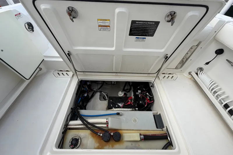 Slide: The Image of Open hatch of a 2015 Boston Whaler 270 Vantage showing internal components and wiring. - 70