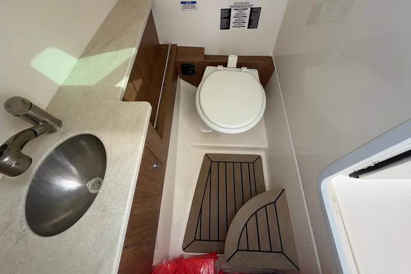 Slide: The Image of Interior of a 2015 Boston Whaler 270 Vantage boat bathroom with sink and toilet. - 32