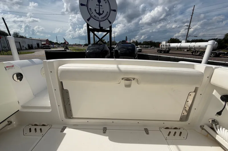 Slide: The Image of 2015 Boston Whaler 270 Vantage boat interior with seating, under a cloudy sky. - 72