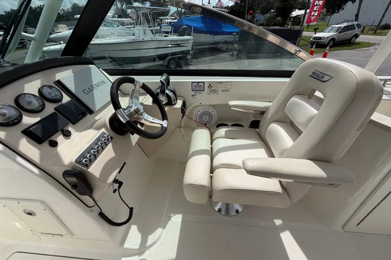 Slide: The Image of Interior of a 2015 Boston Whaler 270 Vantage boat with steering wheel and controls. - 34