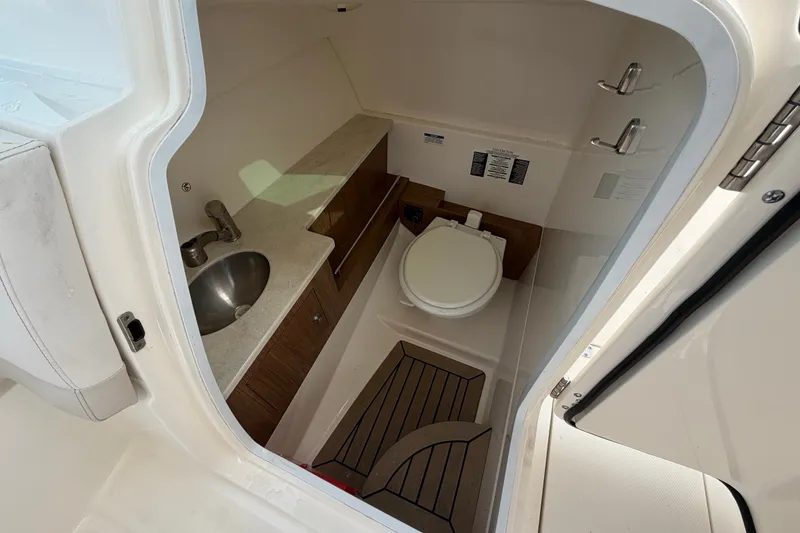 Slide: The Image of Interior of 2015 Boston Whaler 270 Vantage boat bathroom with sink and toilet. - 30