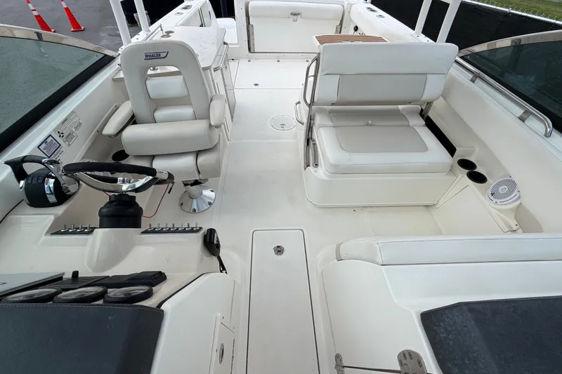 Slide: The Image of 2015 Boston Whaler 270 Vantage boat interior with helm, seating, and controls. - 60