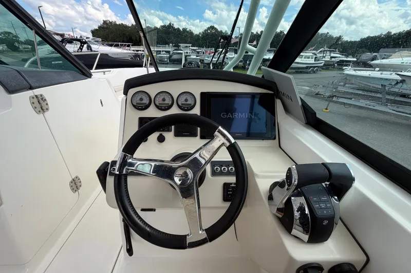 Slide: The Image of 2015 Boston Whaler 270 Vantage helm with Garmin display and steering wheel. - 36