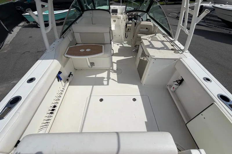 Slide: The Image of 2015 Boston Whaler 270 Vantage boat interior with seating, helm, and storage areas. - 15