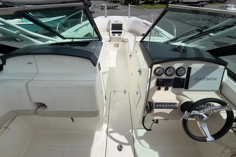 Slide: The Image of 2015 Boston Whaler 270 Vantage boat cockpit with Garmin navigation system and steering wheel. - 33