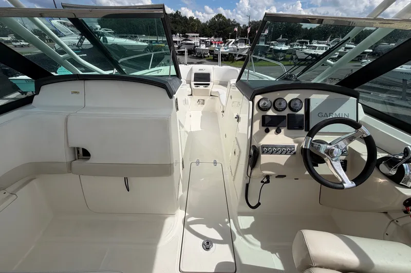 Slide: The Image of 2015 Boston Whaler 270 Vantage boat interior with steering wheel and Garmin navigation system. - 24