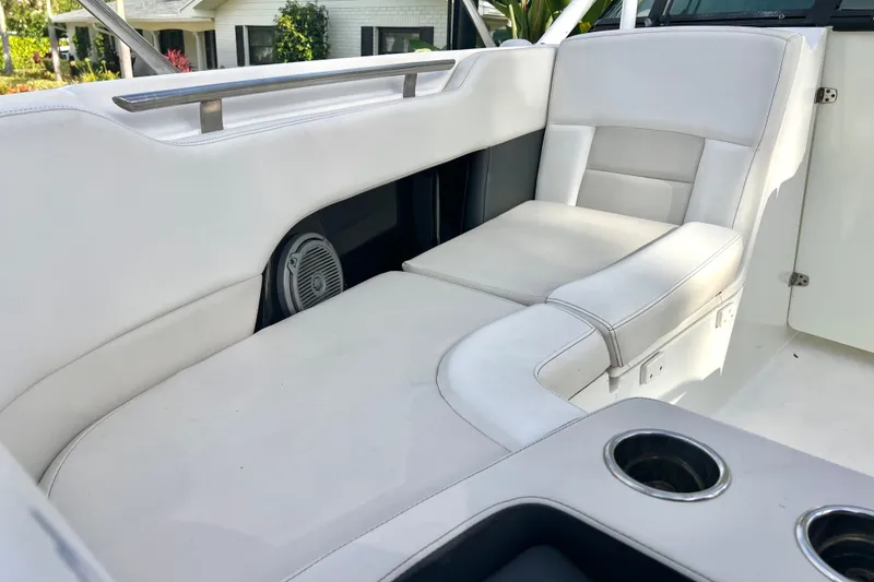 Slide: The Image of 2015 Boston Whaler 270 Vantage interior with white seating and cup holders. - 57