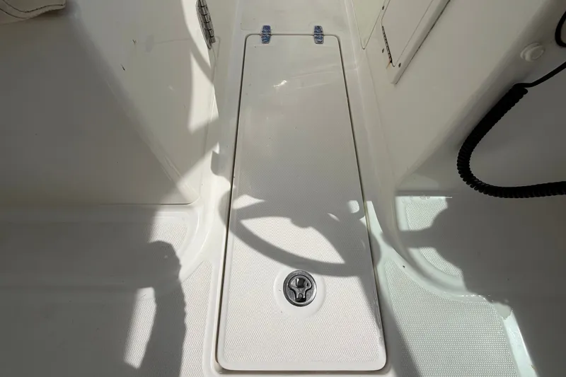 Slide: The Image of 2015 Boston Whaler 270 Vantage deck with storage compartment and latch. - 26