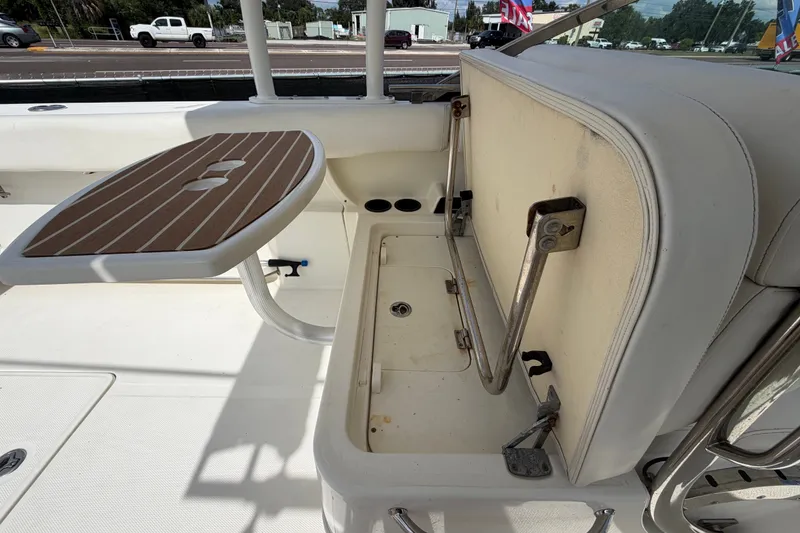 Slide: The Image of 2015 Boston Whaler 270 Vantage interior with foldable seat and wooden table. - 66
